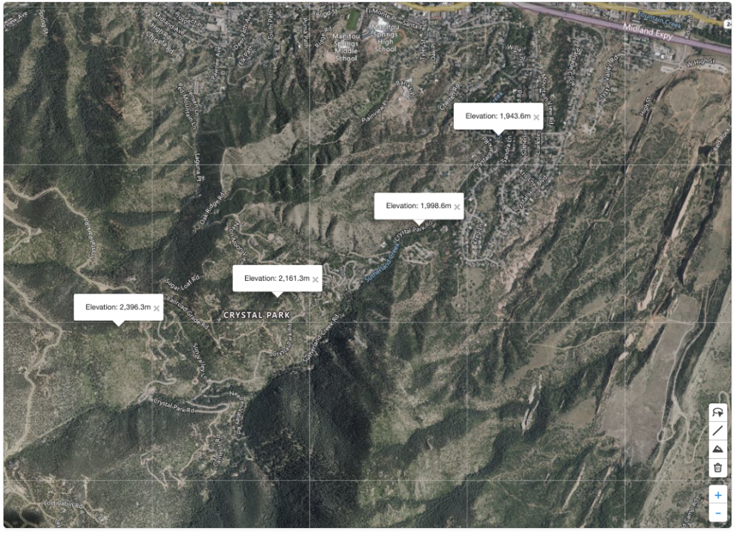 Satellite map view showing multiple elevation callouts placed across a mountainous area. Each label displays the elevation value for its selected point on the map, demonstrating the results of using the lookup elevation tool to identify terrain height at different locations.