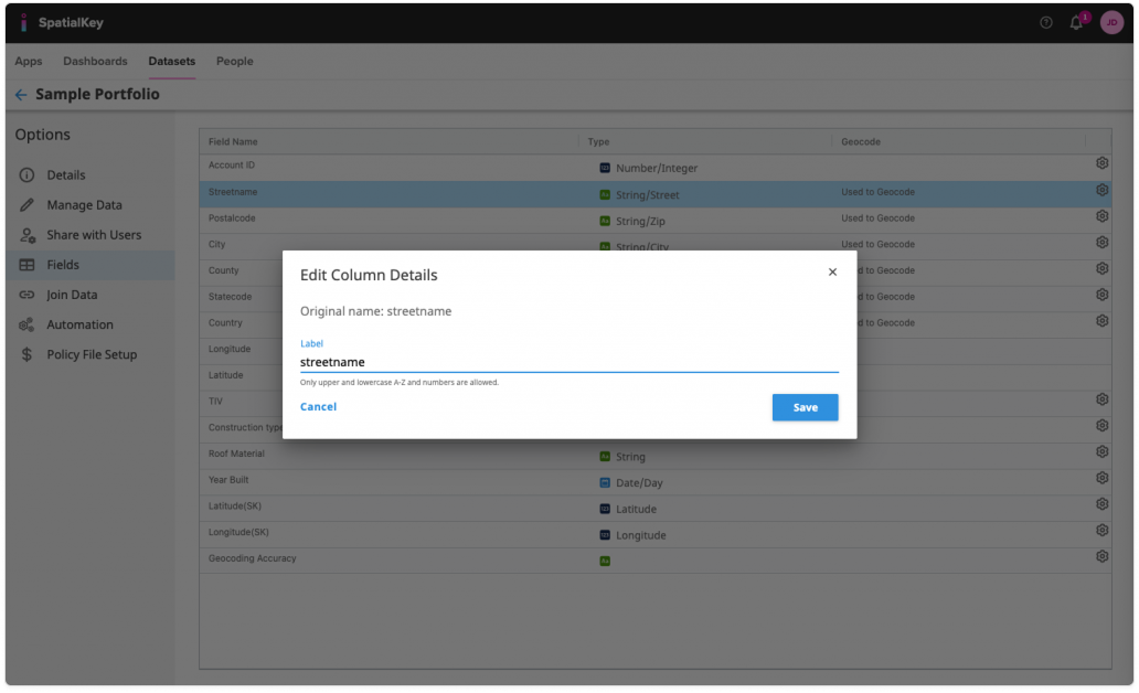 Image of the SpatialKey dataset Fields page with an ‘Edit Column Details’ modal centered on the screen. The modal shows a text field labeled ‘streetname’ and illustrates how clicking the gear (settings) icon next to a field opens this dialog, allowing the user to change the field’s label or format. The background lists multiple fields with data types and settings icons aligned on the right.